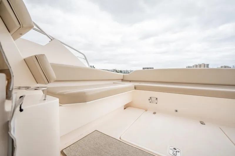 Scrappy G Yacht Photos Pics 2015 Pursuit SC 365i Sport Coupe interior with beige seating and cloudy sky.