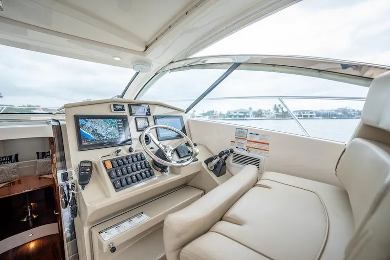Scrappy G Yacht Photos Pics 2015 Pursuit SC 365i Sport Coupe helm with modern navigation equipment and luxurious seating.