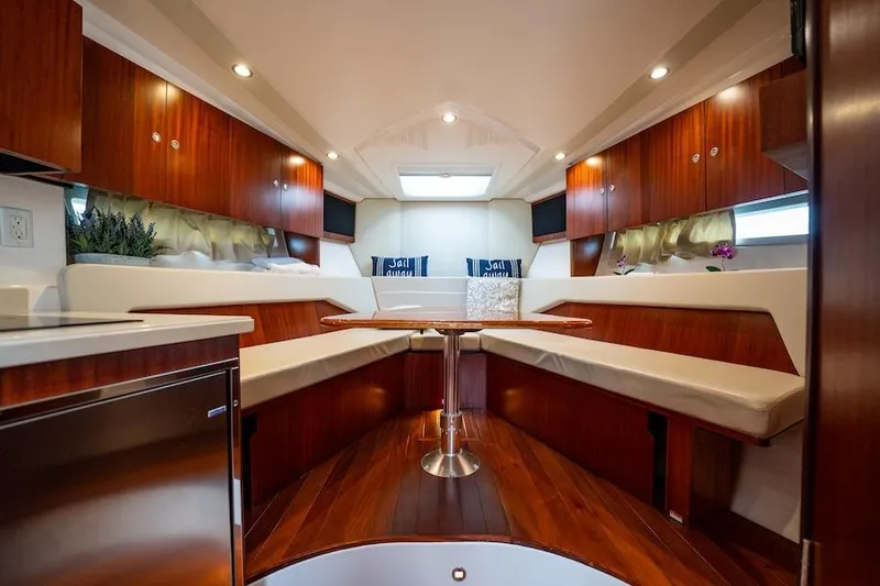 Scrappy G Yacht Photos Pics Luxurious interior of 2015 Pursuit SC 365i Sport Coupe with elegant wood finish and seating.