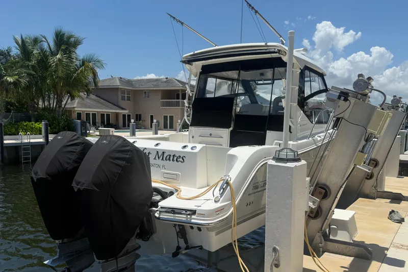  Yacht Photos Pics 2021 Boston Whaler 325 Conquest docked, featuring dual engines and a sleek design.