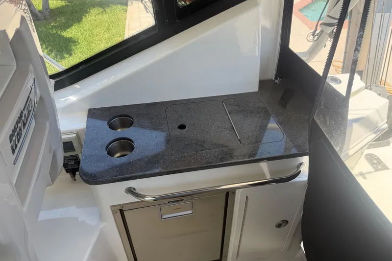  Yacht Photos Pics Boston Whaler 325 Conquest 2021 boat interior with sleek countertop and storage.