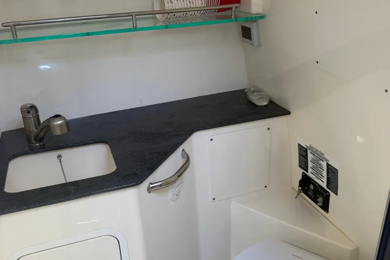  Yacht Photos Pics 2021 Boston Whaler 325 Conquest bathroom with sink, countertop, and storage.