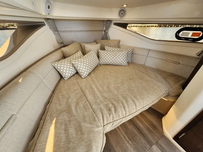  Yacht Photos Pics 2021 Sea Ray 320 Sundancer cabin interior with plush seating and decorative pillows.