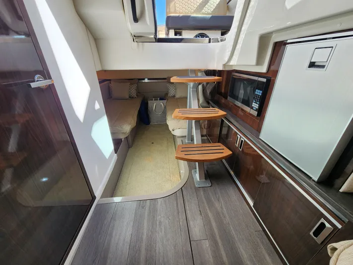  Yacht Photos Pics Interior of 2021 Sea Ray 320 Sundancer yacht with modern kitchen and cozy seating area.
