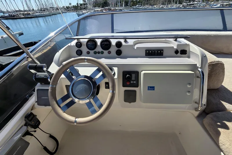  Yacht Photos Pics Cockpit of 2012 Azimut Fly 60 yacht with steering wheel and control panel.