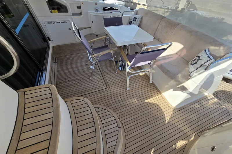  Yacht Photos Pics Azimut Fly 60 yacht deck, 2012 model, featuring seating and a table on teak flooring.