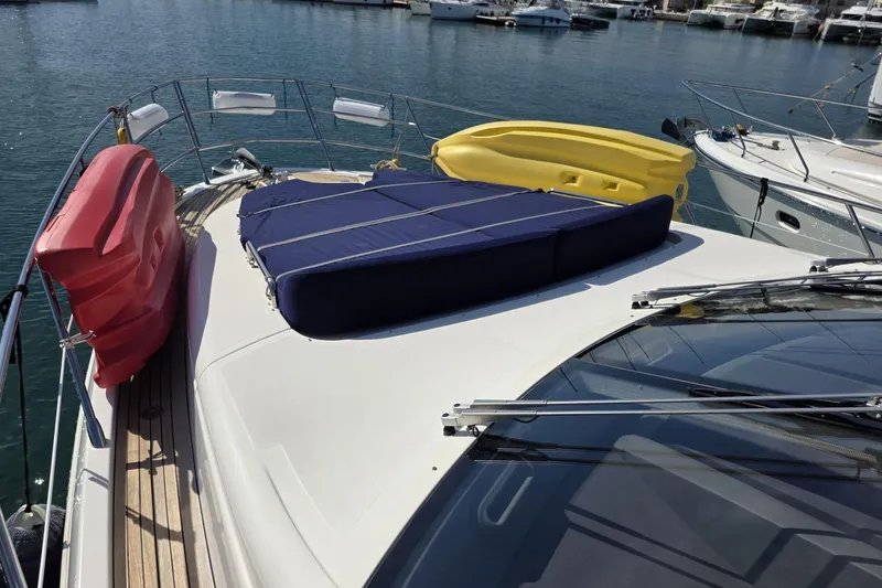  Yacht Photos Pics 2012 Azimut Fly 60 yacht deck with colorful cushions in a marina setting.