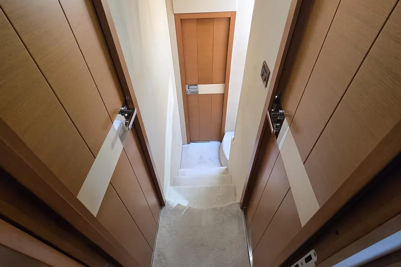  Yacht Photos Pics Narrow hallway with wooden doors inside a 2012 Azimut Fly 60 yacht.