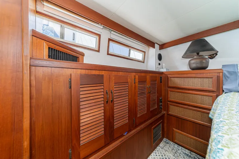 Cynful One Yacht Photos Pics Interior of 1982 Viking 44 Motor Yacht with wooden cabinetry and decorative lamp.