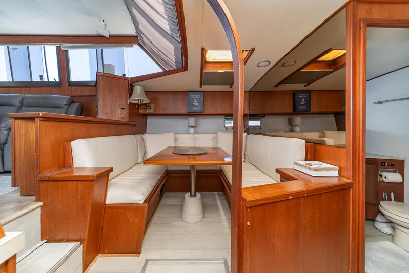 Cynful One Yacht Photos Pics 1982 Viking 44 Motor Yacht interior with wood finish and cozy seating area.