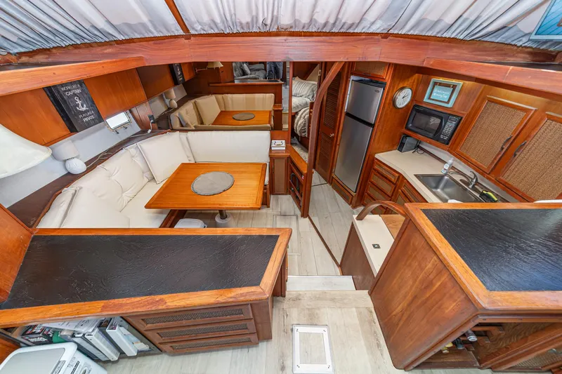 Cynful One Yacht Photos Pics Interior of 1982 Viking 44 Motor Yacht with kitchen and dining area.