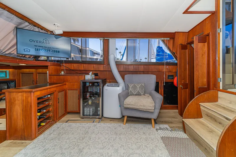 Cynful One Yacht Photos Pics Interior of 1982 Viking 44 Motor Yacht with wooden cabinetry and cozy seating area.