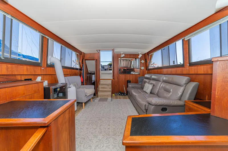 Cynful One Yacht Photos Pics Luxurious interior of 1982 Viking 44 Motor Yacht with leather seating and wood paneling.