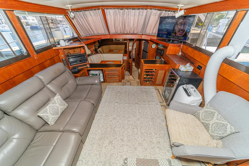 Cynful One Yacht Photos Pics Interior of 1982 Viking 44 Motor Yacht with cozy seating and entertainment area.