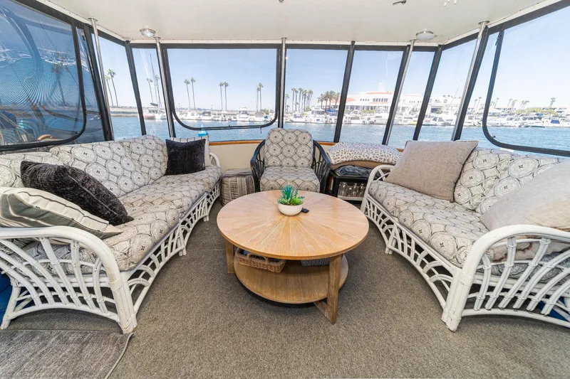 Cynful One Yacht Photos Pics Cozy interior of 1982 Viking 44 Motor Yacht with wicker seating and ocean view.