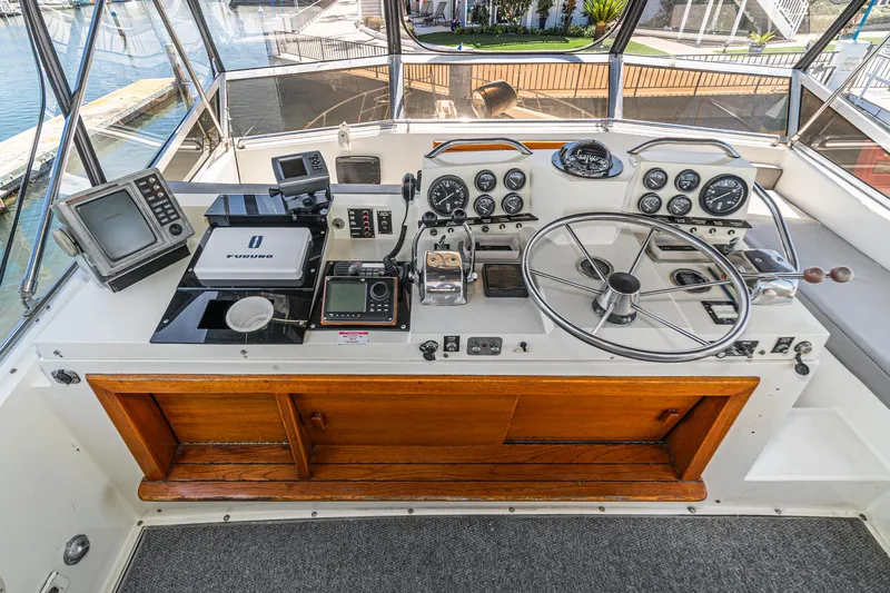 Cynful One Yacht Photos Pics 1982 Viking 44 Motor Yacht helm with navigation equipment and steering wheel.