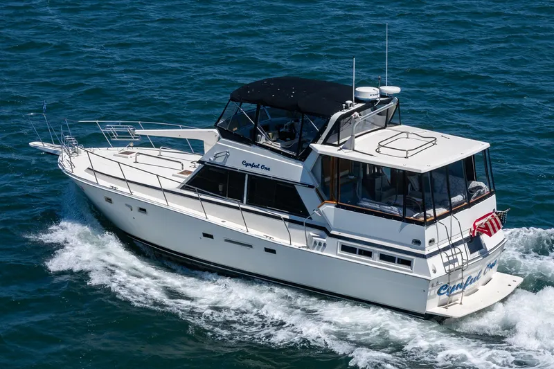 Cynful One Yacht Photos Pics 1982 Viking 44 Motor Yacht cruising on open water, featuring sleek design and spacious deck.