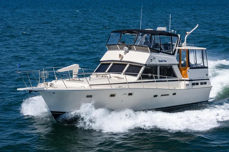 Cynful One Yacht Photos Pics 1982 Viking 44 Motor Yacht cruising on open water.