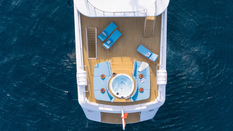 Grand Cru Yacht Photos Pics Aerial view of Baglietto 49M yacht deck with jacuzzi and lounge chairs, 1995 model.