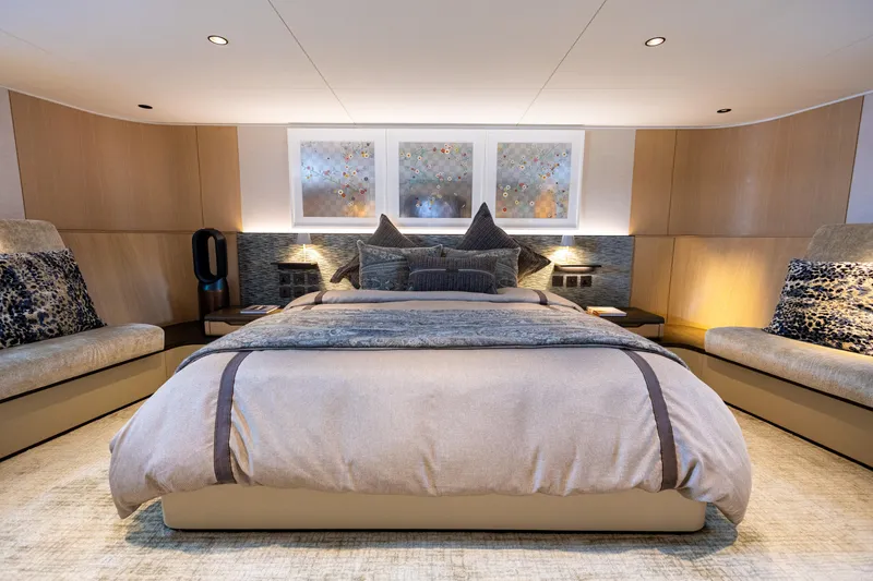 Grand Cru Yacht Photos Pics Luxurious bedroom interior on a 1995 Baglietto 49M yacht, featuring elegant bedding and modern decor.