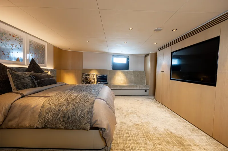 Grand Cru Yacht Photos Pics Luxurious bedroom interior of 1995 Baglietto 49M yacht with elegant decor and large TV.