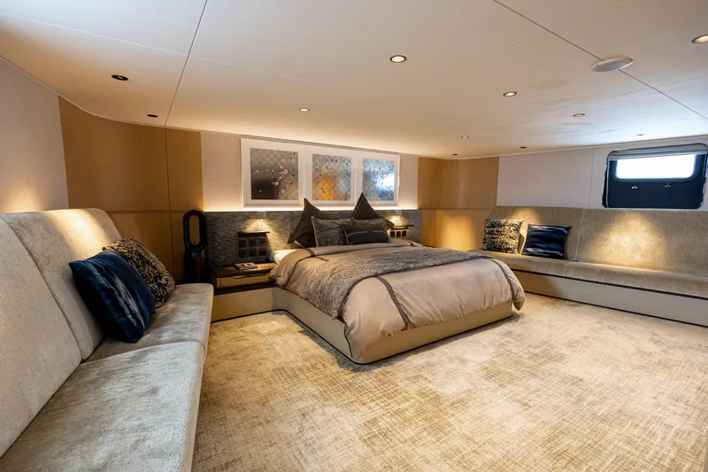 Grand Cru Yacht Photos Pics Luxurious bedroom interior on a 1995 Baglietto 49M yacht, featuring elegant decor and ambient lighting.