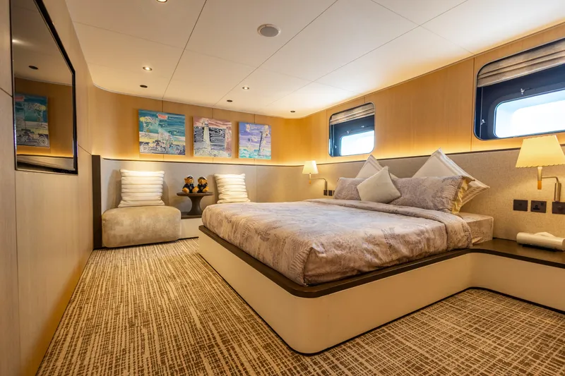 Grand Cru Yacht Photos Pics Luxurious bedroom interior on 1995 Baglietto 49M yacht, featuring elegant decor and modern amenities.