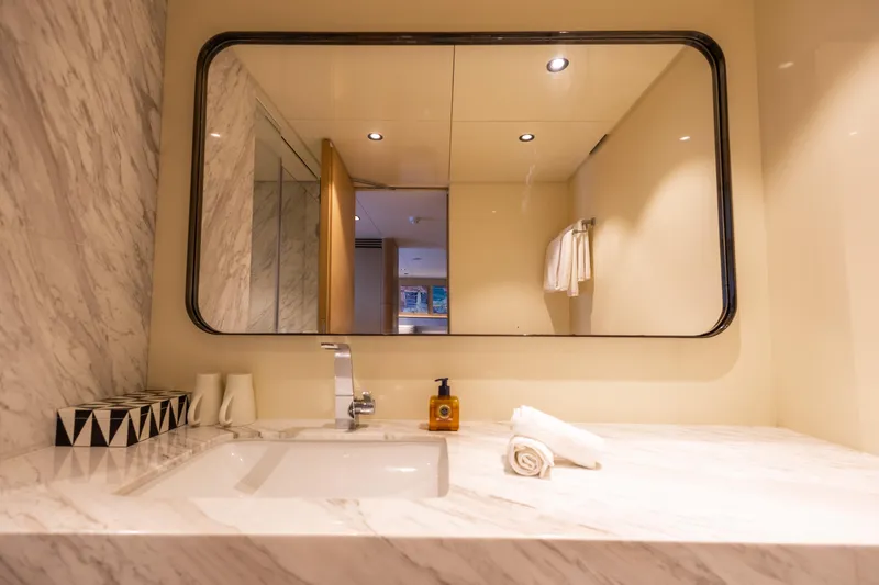 Grand Cru Yacht Photos Pics Luxurious bathroom on 1995 Baglietto 49M yacht with marble sink and large mirror.
