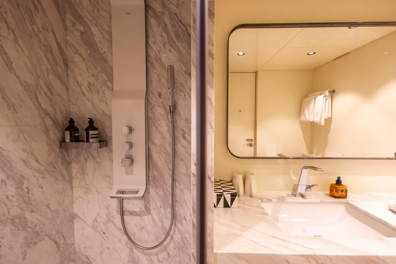 Grand Cru Yacht Photos Pics Luxurious marble bathroom in 1995 Baglietto 49M yacht with modern shower and elegant fixtures.