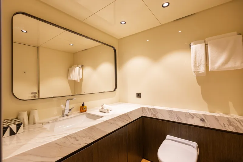 Grand Cru Yacht Photos Pics Luxurious bathroom on Baglietto 49M yacht, featuring marble countertop and modern fixtures, 1995 model.