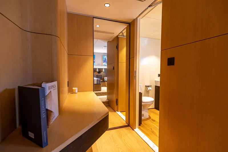 Grand Cru Yacht Photos Pics Luxurious interior of 1995 Baglietto 49M yacht featuring wooden paneling and modern bathroom.