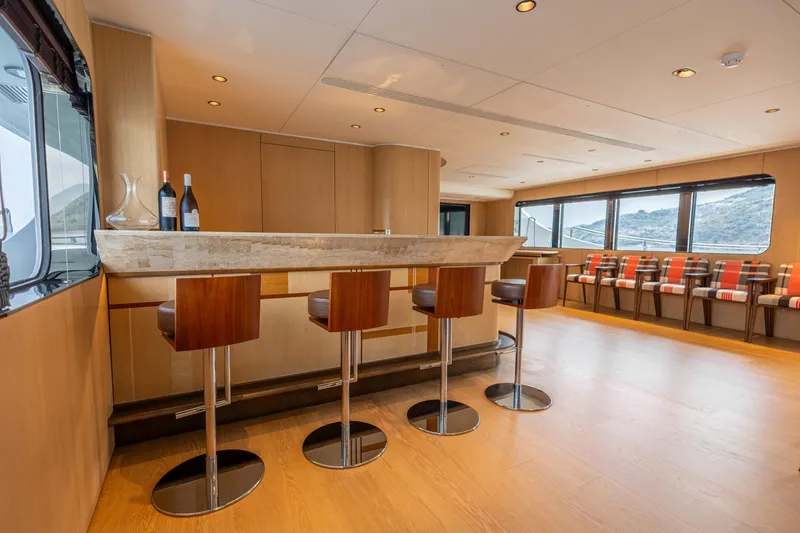 Grand Cru Yacht Photos Pics Luxurious interior of 1995 Baglietto 49M yacht with modern bar and seating area.