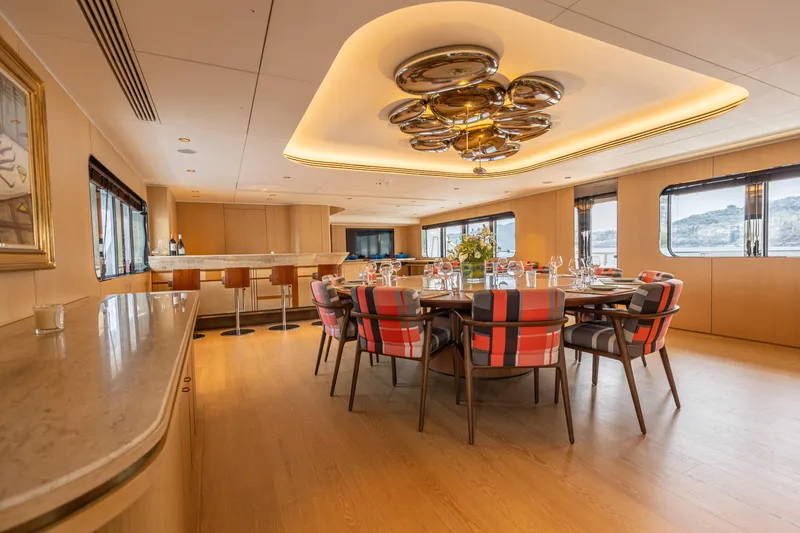 Grand Cru Yacht Photos Pics Luxurious dining area on 1995 Baglietto 49M yacht with modern decor and elegant seating.