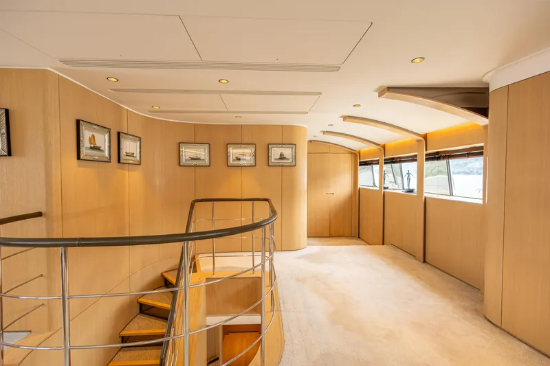Grand Cru Yacht Photos Pics Luxurious interior of 1995 Baglietto 49M yacht with elegant wood paneling and framed artwork.