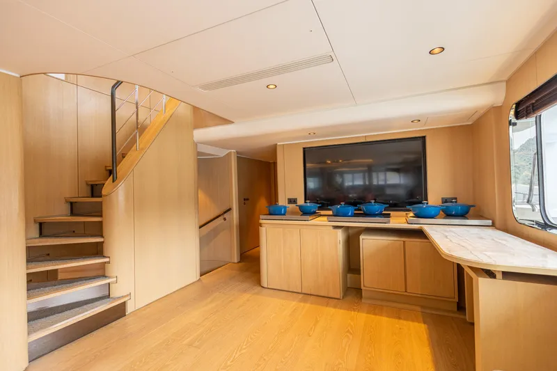 Grand Cru Yacht Photos Pics Luxurious interior of 1995 Baglietto 49M yacht with modern wood finishes and elegant staircase.