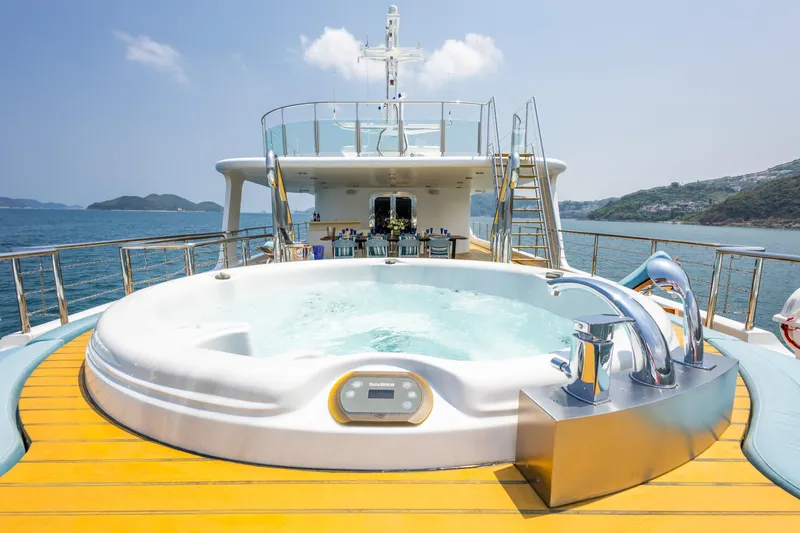 Grand Cru Yacht Photos Pics Luxurious Baglietto 49M yacht deck with jacuzzi, ocean view, and clear sky.