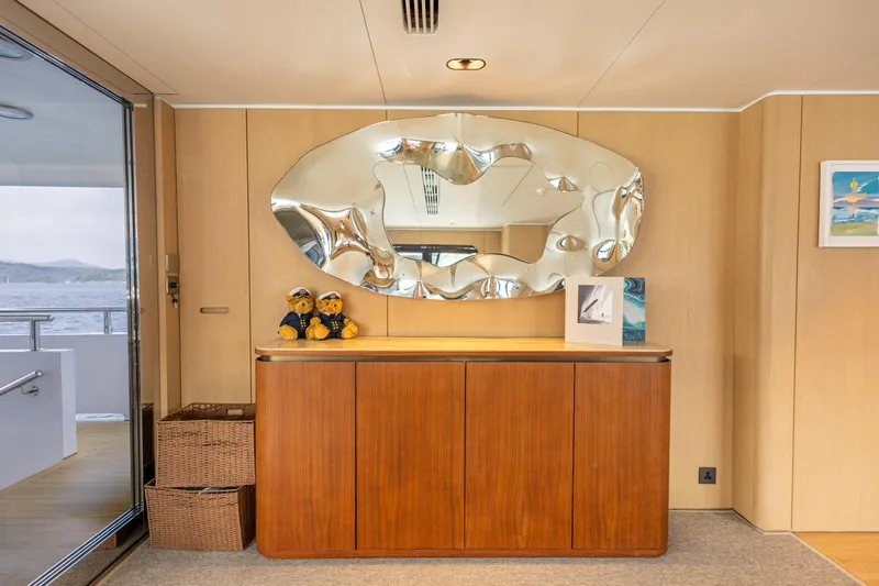 Grand Cru Yacht Photos Pics Luxury yacht interior with modern decor, featuring a unique mirror and wooden cabinet. Baglietto 49M, 1995.