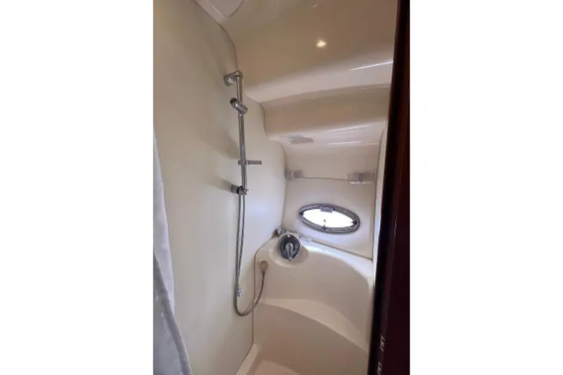 Seas The Reins Yacht Photos Pics Shower area in 2006 Silverton 43 Sport Bridge yacht with porthole window.