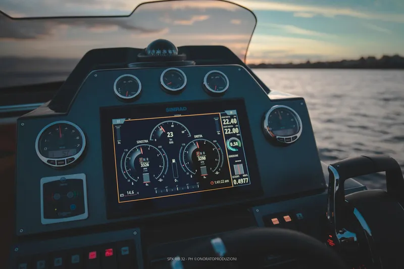  Yacht Photos Pics SPX RIB 32 Dinette 2025 dashboard with digital display at sunset on water.