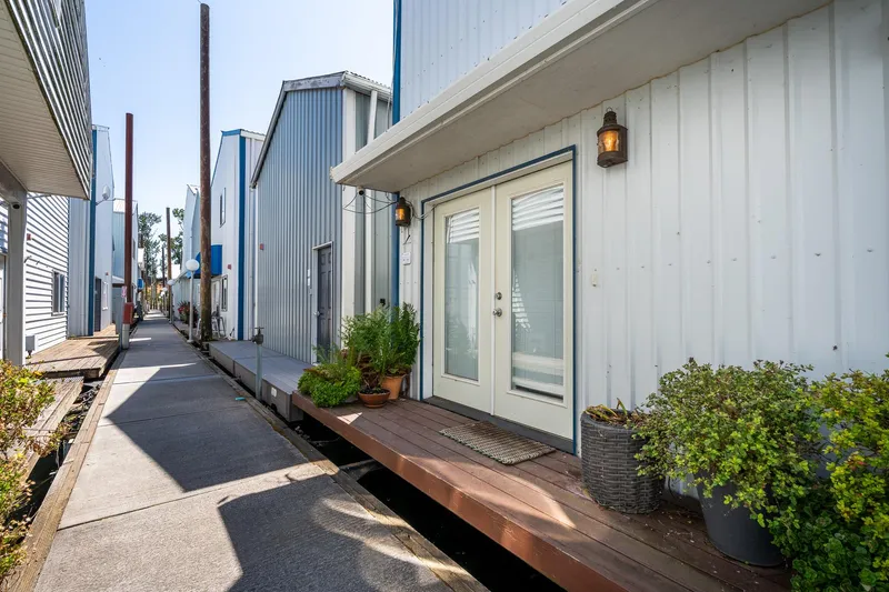  Yacht Photos Pics Modern Steelhead Boathouse exterior with plants, wooden deck, and walkway, built in 2006.