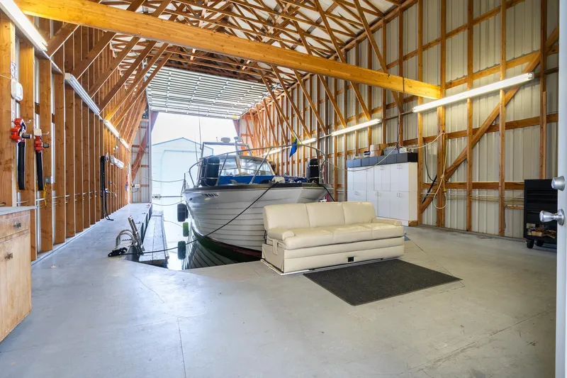  Yacht Photos Pics Spacious boathouse interior with docked boat and cozy seating area, 2006 Steelhead model.