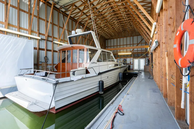  Yacht Photos Pics Custom Steelhead Boathouse 2006 with wooden interior, docked in a spacious boathouse.