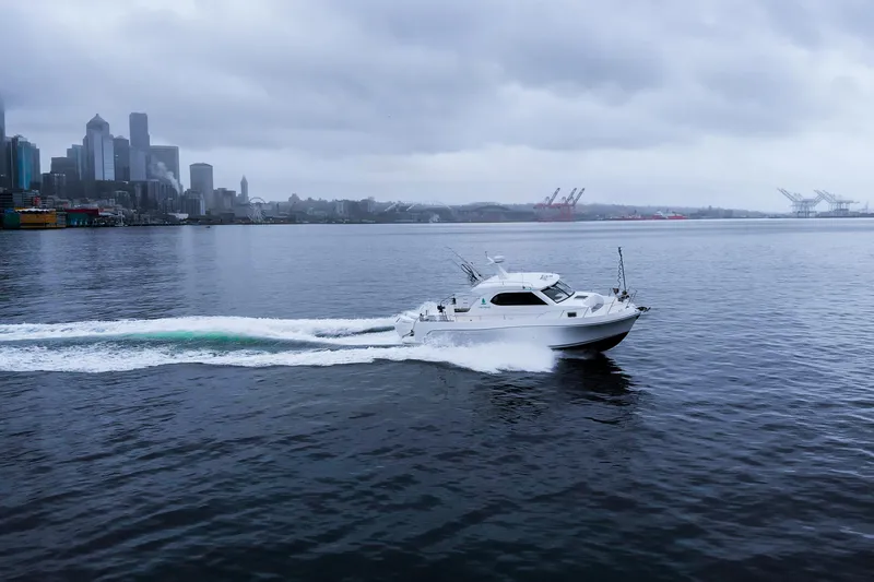  Yacht Photos Pics 2025 Bracewell Commander 36SF cruising near city skyline on a cloudy day.