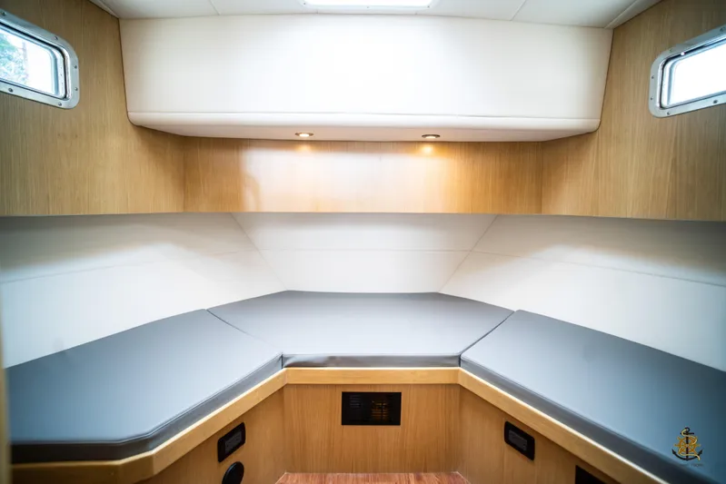  Yacht Photos Pics Interior cabin of 2025 Bracewell Commander 36SF with modern wood finish and cushioned seating.