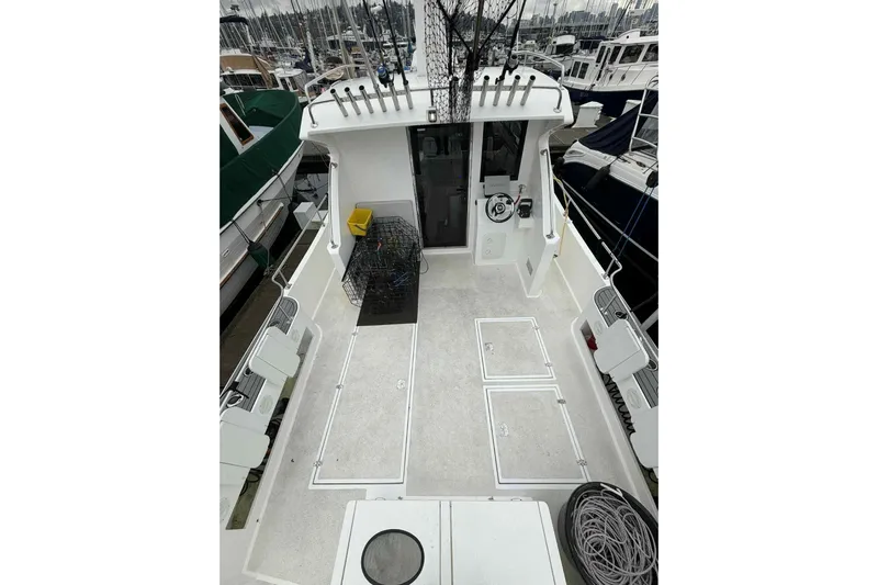  Yacht Photos Pics 2025 Bracewell Commander 36SF boat deck with fishing gear and storage compartments.