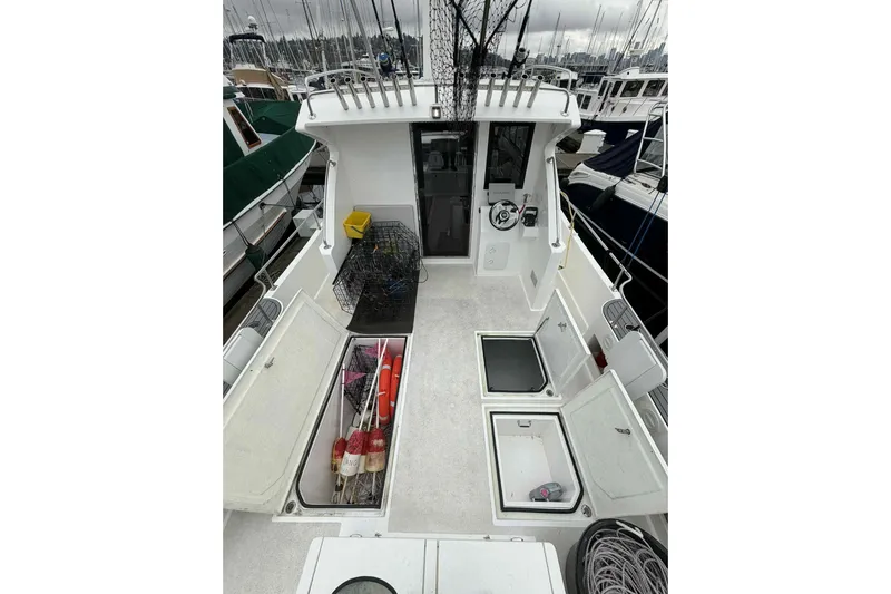  Yacht Photos Pics 2025 Bracewell Commander 36SF boat deck with storage compartments and fishing gear.