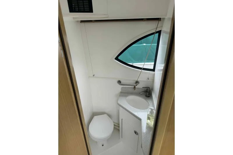  Yacht Photos Pics Compact bathroom in 2025 Bracewell Commander 36SF boat with modern fixtures and oval window.