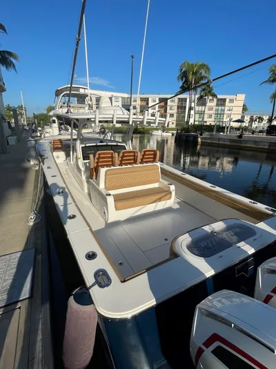  Yacht Photos Pics 2021 Valhalla Boatworks V-41 docked in a marina, featuring sleek design and spacious seating.