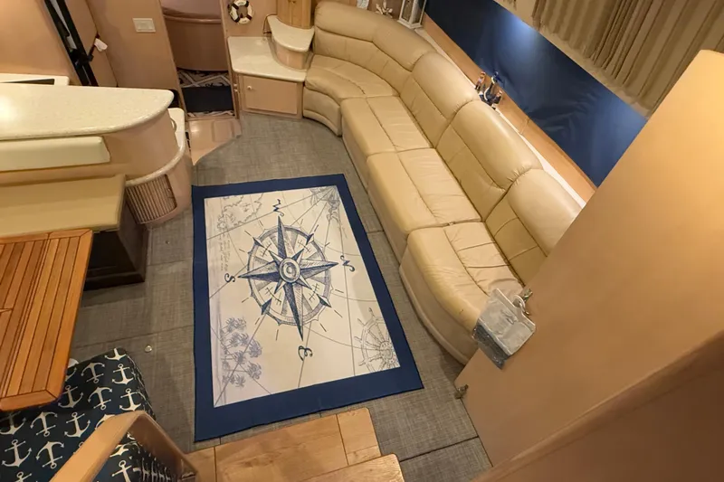 Allegedly Yacht Photos Pics Luxurious interior of 2000 Carver 396 Motor Yacht with beige seating and nautical-themed decor.