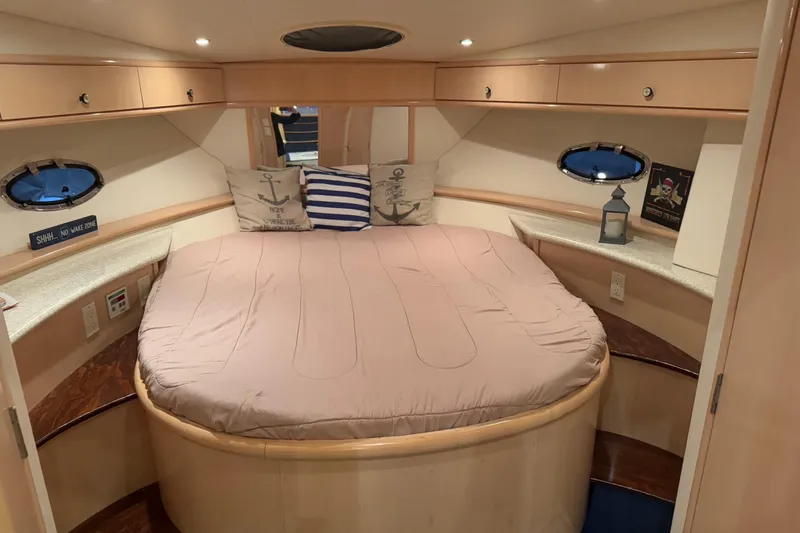Allegedly Yacht Photos Pics Interior of 2000 Carver 396 Motor Yacht bedroom with cozy bed and nautical decor.